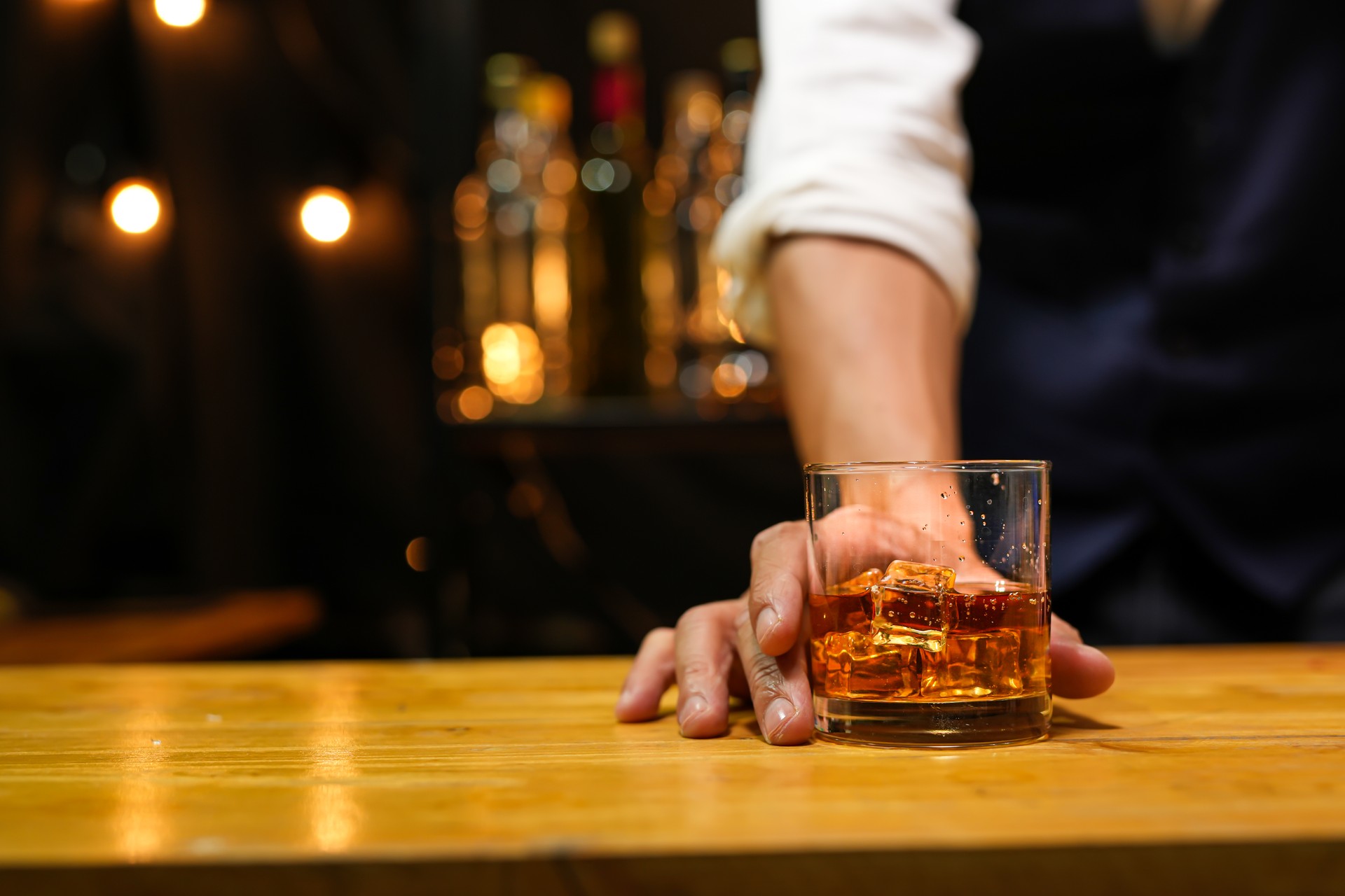 Bartender pouring Whiskey, on  bar,